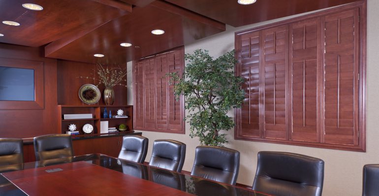 Brown-red shutters covering a window in a business conference room